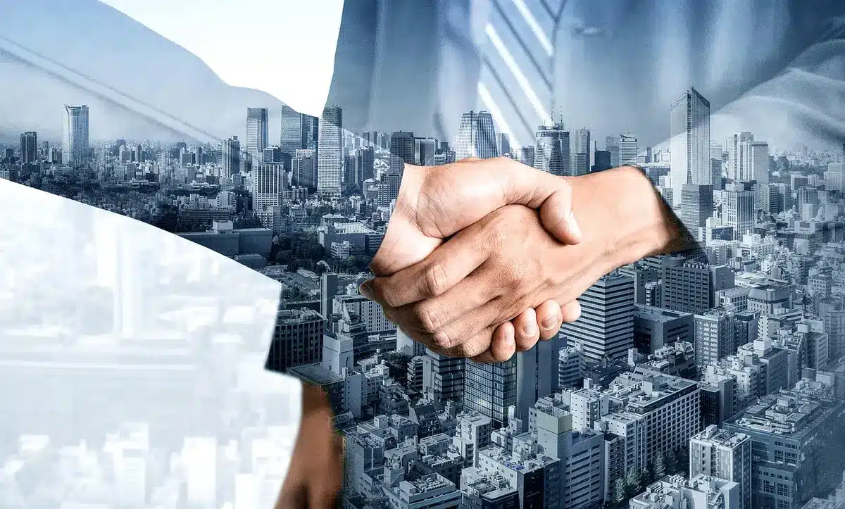 Due professionisti siglano un accordo commerciale, simbolo della vendita di Alfahealth e IndX ad Accenture